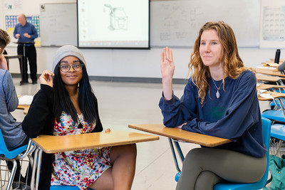 two ASL students signing in a classroom
