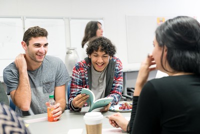 group of students discussing textbook material